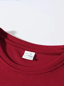 Close-up of red breathable mesh t-shirt neckline showing size S polyester wash label