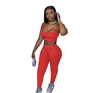 Casual women's red two-piece sports set with cropped camisole and slim leggings.