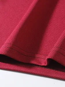 Close-up of the breathable red mesh fabric texture of this athletic men's sports tank top