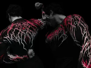 Detail view of Breathedivinity men's gym compression shirt with skull and red branch print