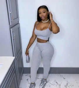Women's grey two-piece casual sportswear set with crop top and leggings on model