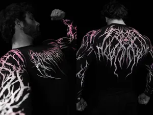 Detailed view of men's black compression gym shirt with pink gothic thorn pattern