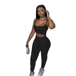 Sleek black two-piece workout set with camisole crop top and matching leggings