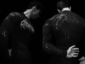 Detail of black men's compression gym shirt with gothic graphic print by Breathedivinity