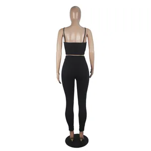 Rear view of women's black two-piece sports set with camisole top and leggings.