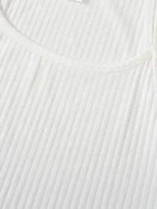 Close-up macro view of the white ribbed knit fabric texture on a men's athletic tank top