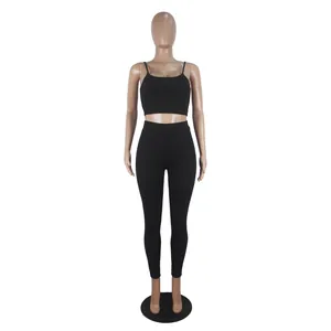 Full view of women's black two-piece workout set with camisole crop top and fitted leggings