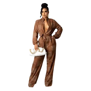Full-body view of brown long-sleeved jumpsuit with cursive text print and belt