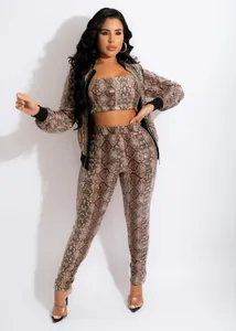 Detailed view of women's three-piece snake print set with cardigan, tube top, and pants