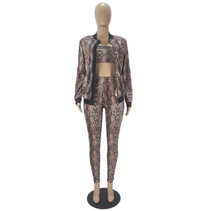 Close-up view of a three-piece snakeskin print women's set including jacket, top and leggings