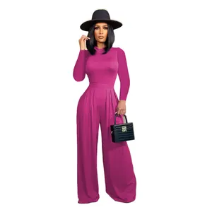 Fashionable magenta long sleeve top and wide leg pants set featuring a black hat accessory