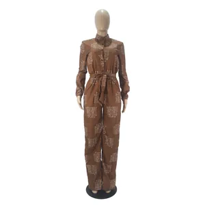Elegant brown long sleeve belted jumpsuit featuring a white script print design detail