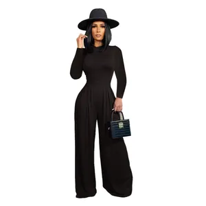 Elegant black long-sleeve top and wide-leg trouser set with a matching hat and bag.