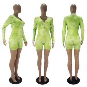 Detailed views of women's green Leo zodiac print long sleeve shorts romper jumpsuit