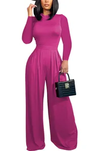 Full length view of fuchsia bodysuit paired with pleated high waist wide leg pants.