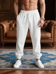 Men's breathable white linen cuffed joggers for a luxury casual summer vacation look