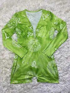Detail showing green Leo zodiac print and metal buttons on the long-sleeve romper