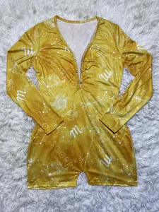 Close-up of yellow long sleeve romper with Scorpio constellation print and V-neck.