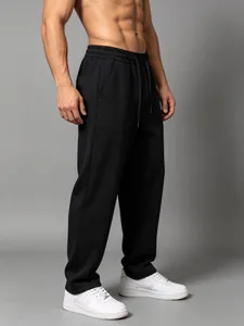 Detailed view of men's loose black cotton sports joggers with straight-leg design