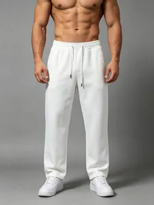 Detail of men's white loose-fit straight-leg sweatpants showing fabric texture and drape