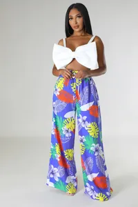 Modische Damen-Hose mit tropischem Print und weitem Bein sowie weißem Schleifen-Crop-Top.