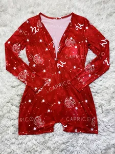 Detailed view of the Capricorn zodiac constellation print on red long-sleeved home romper