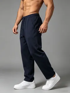 Detail view of men's loose navy blue straight-leg sweatpants for fitness and casual wear