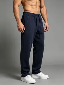 Lower body detail view of men's navy blue sports joggers paired with white sneakers.