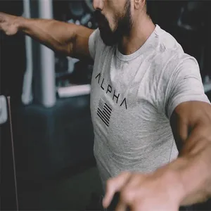 Close-up detail of a gray men's muscle fit gym t-shirt featuring ALPHA text print