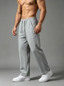 Detailed view of men's gray loose fit athletic sweatpants featuring drawstring waist