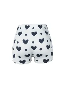 Vue détaillée du short de yoga blanc pour femme avec motifs de cœurs et pois noirs.