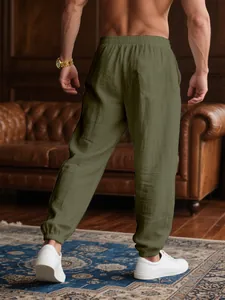 Back view of men's breathable olive green casual jogger pants with elasticated ankle cuffs