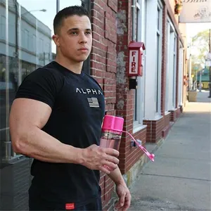 Detail of muscle fit black sport t-shirt with ALPHA print and pink water bottle
