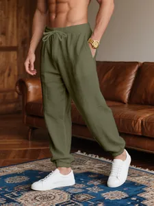 Close-up of olive green breathable cotton linen joggers for men in a lounge setting