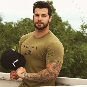 Detail of a muscular fit olive green sports t-shirt for men worn by a fitness model