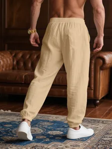Men's loose tan casual joggers with breathable fabric and elasticated ankle cuffs back view