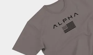 Close-up of the stylized Alpha print and American flag on a men's grey sports t-shirt