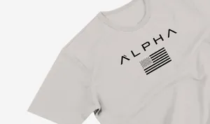 Detailed close-up of ALPHA text and flag print on a light grey men's crew neck athletic t-shirt