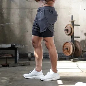 Side view of men's gray 2-in-1 quick-dry athletic shorts for gym and running
