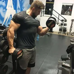 Muscular man in gym wearing a black quick-dry compression shirt for fitness training