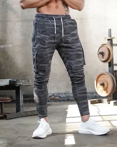 Detailed view of men's slim-fit camouflage cargo joggers in a professional gym