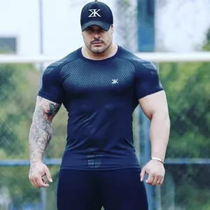 Muscular male athlete wearing black short sleeve compression fitness t-shirt outdoors