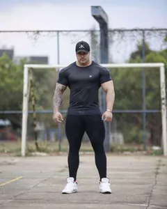 Men's athletic black compression t-shirt designed for bodybuilding and muscle training workouts.