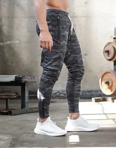 Detailed shot of men's camouflage cargo joggers in a professional gym setting