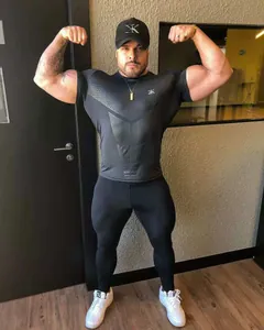 Detailed view of muscular model wearing a tight-fitting black gym t-shirt