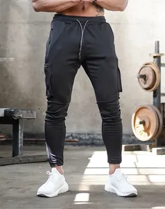 Detailed view of men's slim-fit black gym cargo joggers featuring multiple zipper pockets