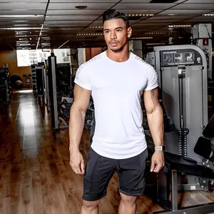 Professional male athlete in white high-stretch fitness T-shirt and black gym shorts