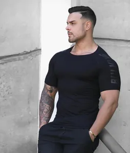 Close-up detail of men's high-elastic black quick-dry fitness compression t-shirt