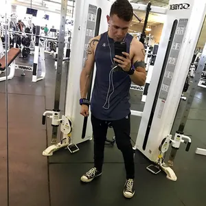 Men's slim fit black gym joggers worn during a workout in a professional gym setting