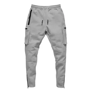 Close-up detail of men's grey cargo joggers showing multi-pockets and ankle zippers